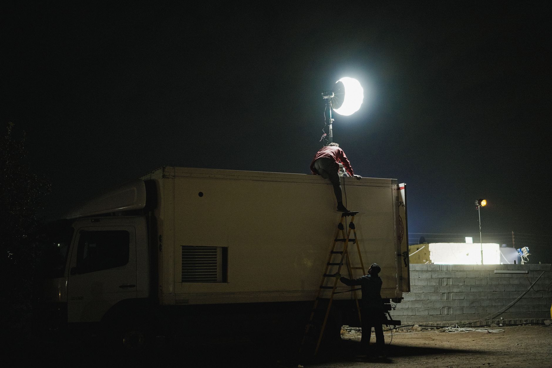 Film crew shooting on a city street at night